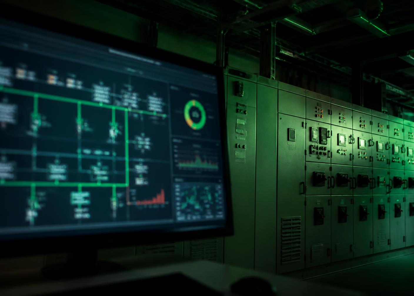 Energy management control screen beside switchgear at a commercial microgrid